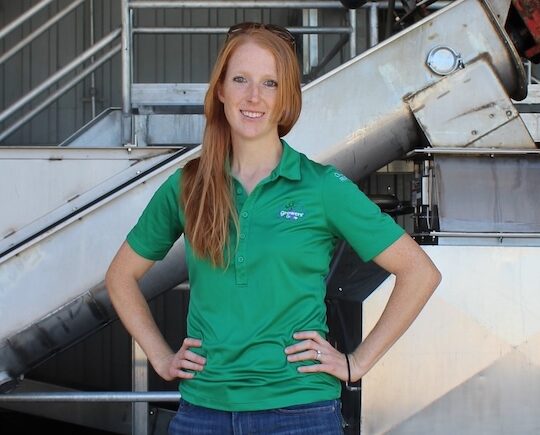 Woman in green shirt in manufacturing facility