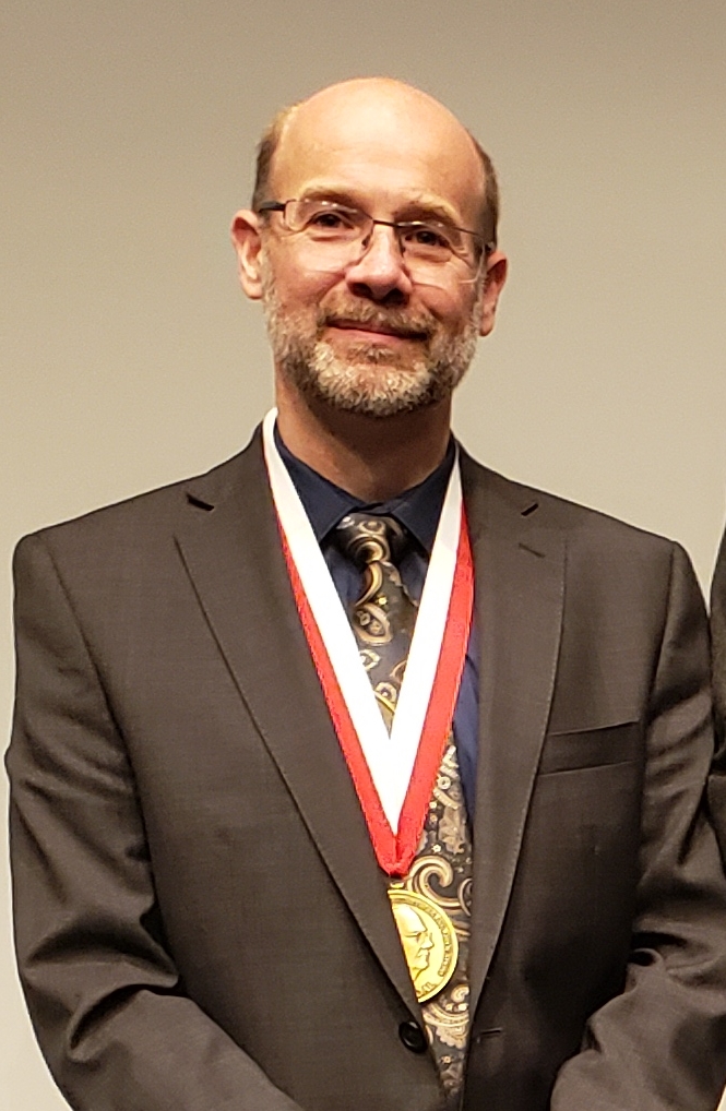 Dean Adams wearing his Rohlf Medal