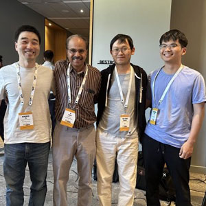 Four guys standing together posing for a photo