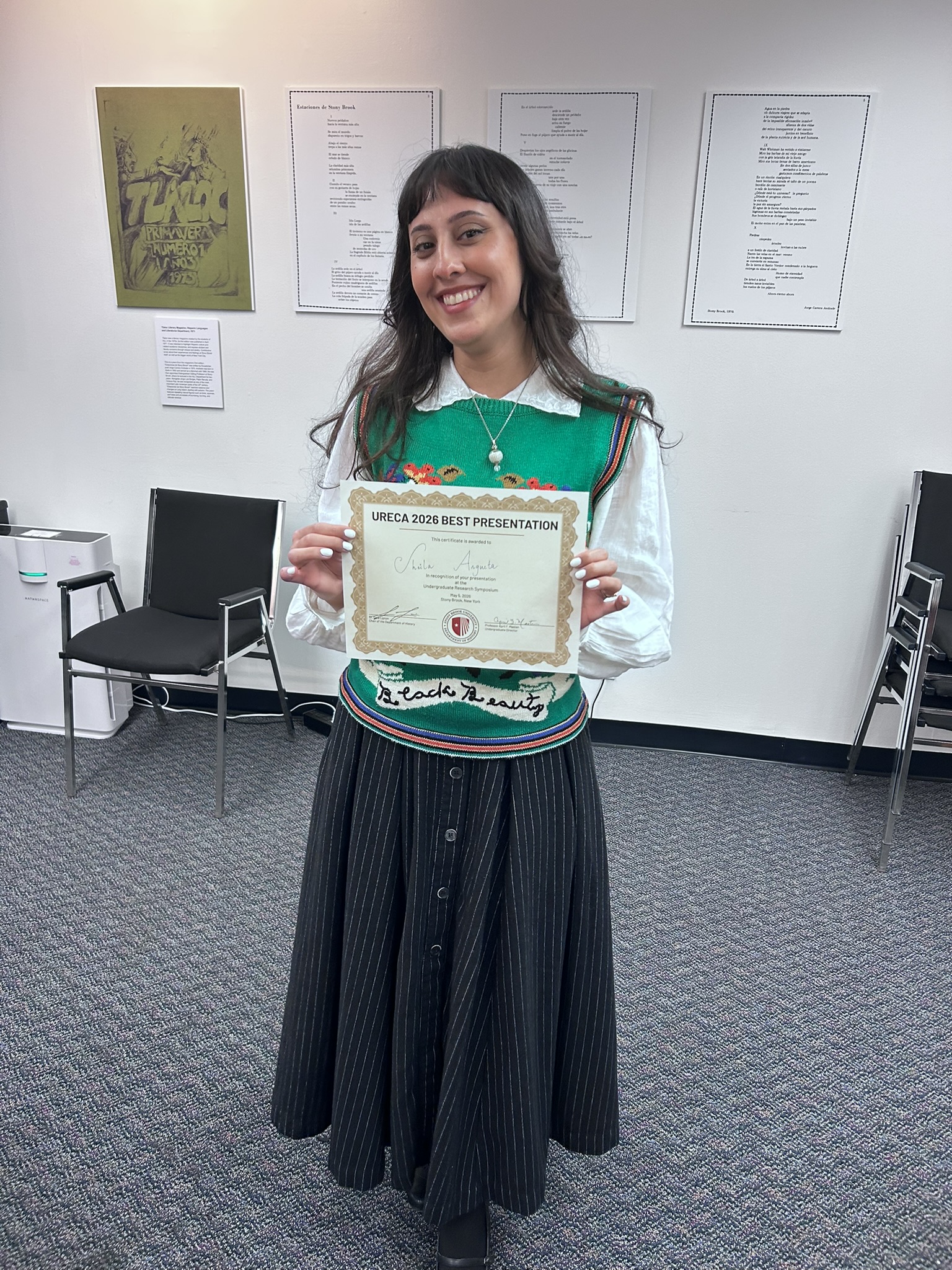 History Alumna Sheila Argueta holding a certificate