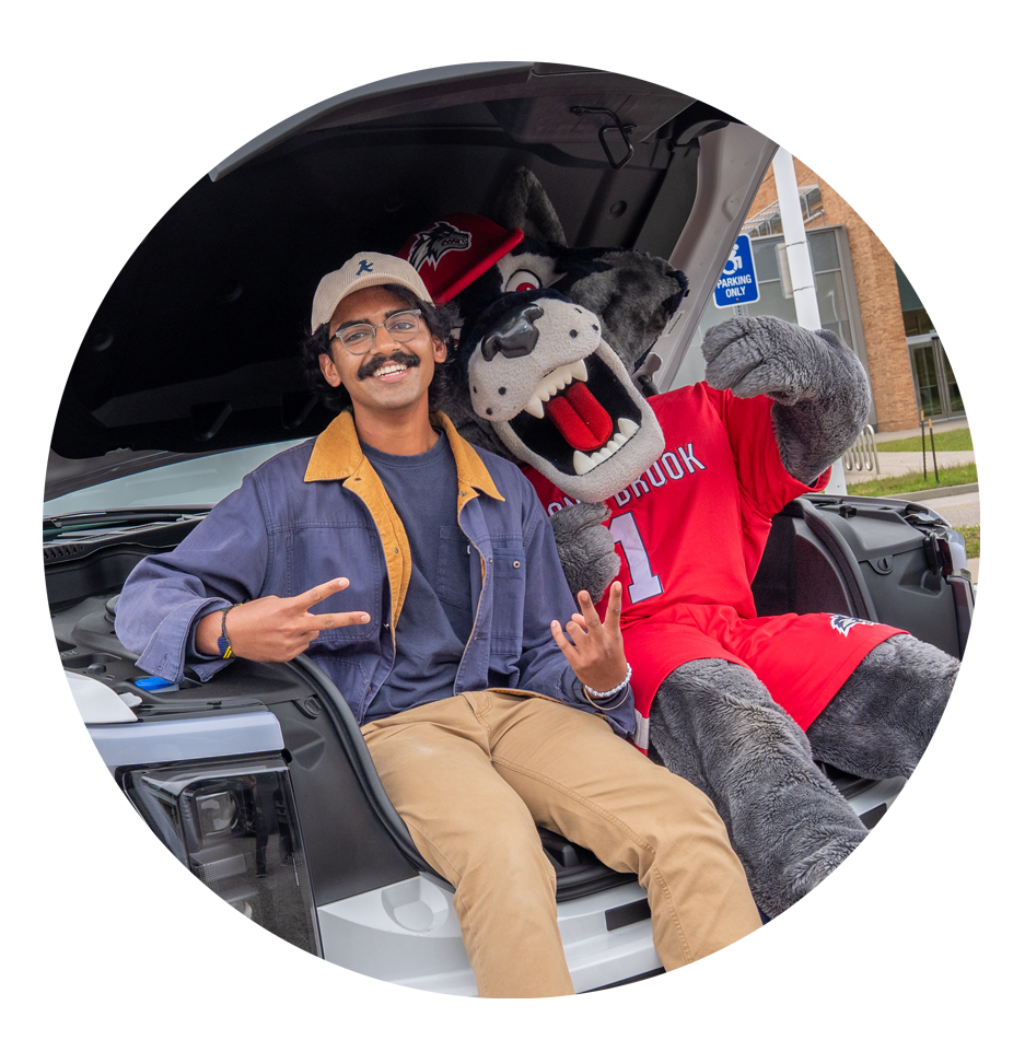 student posing with Wolfie