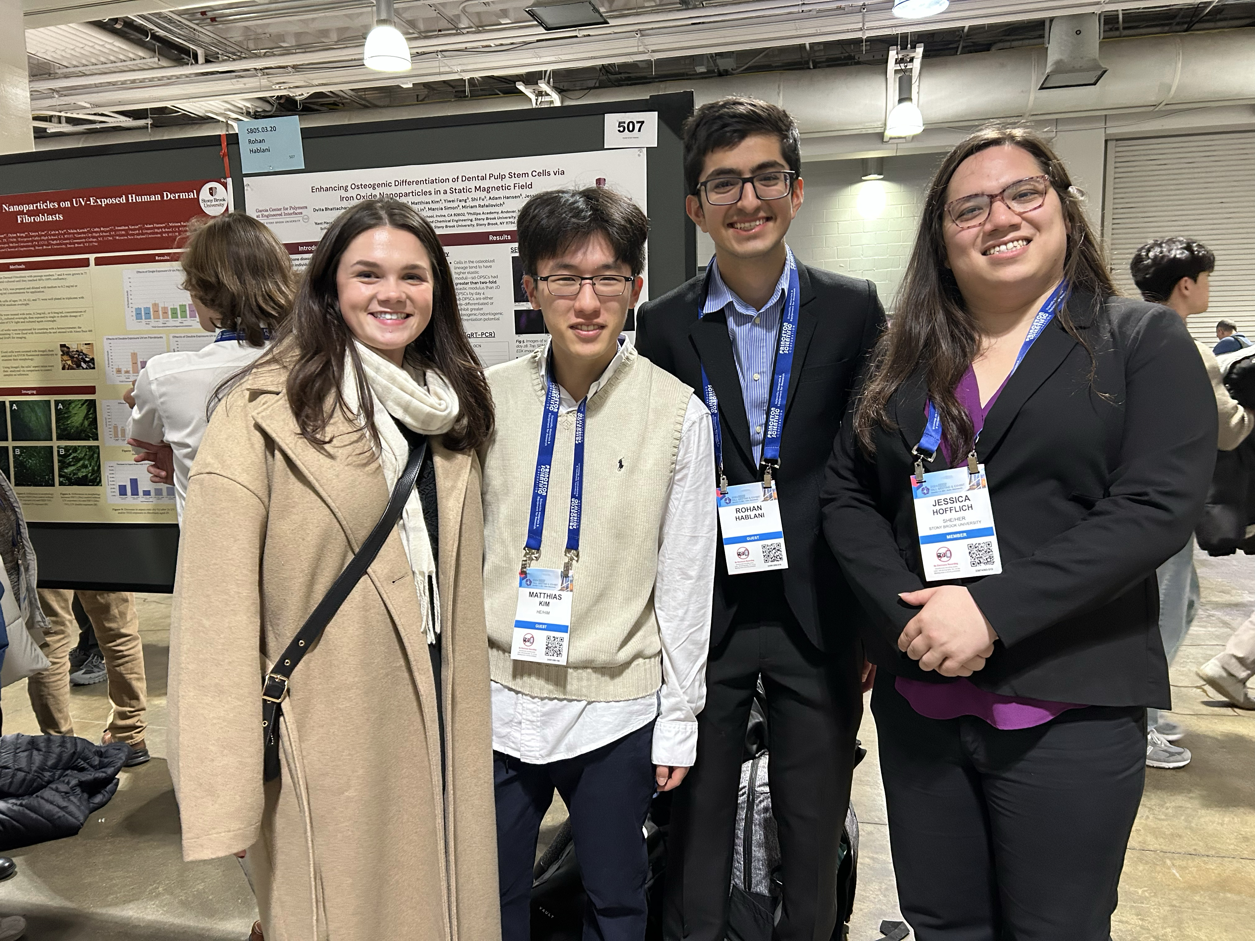 Four students standing at a conference