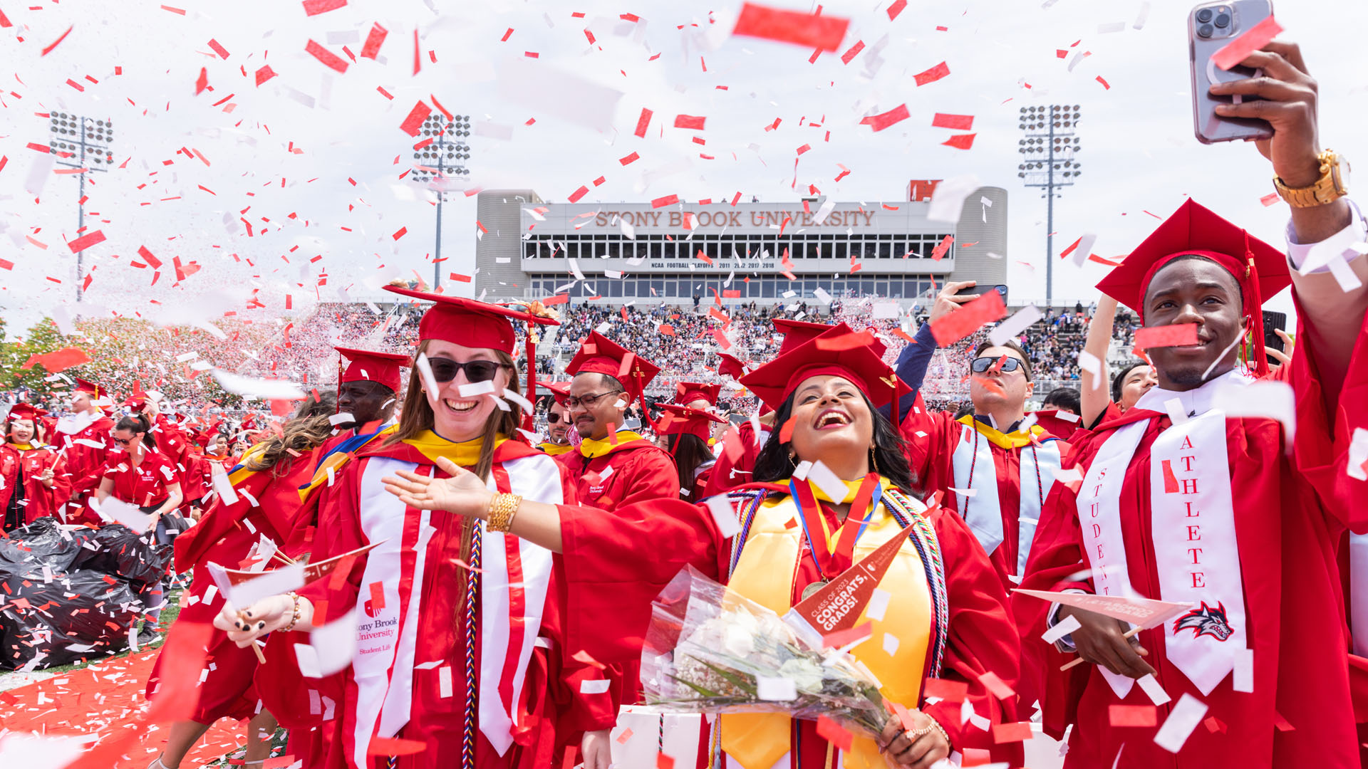 SBU graduates smiling and celebrating