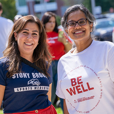 faculty and student in Be Well tshirt