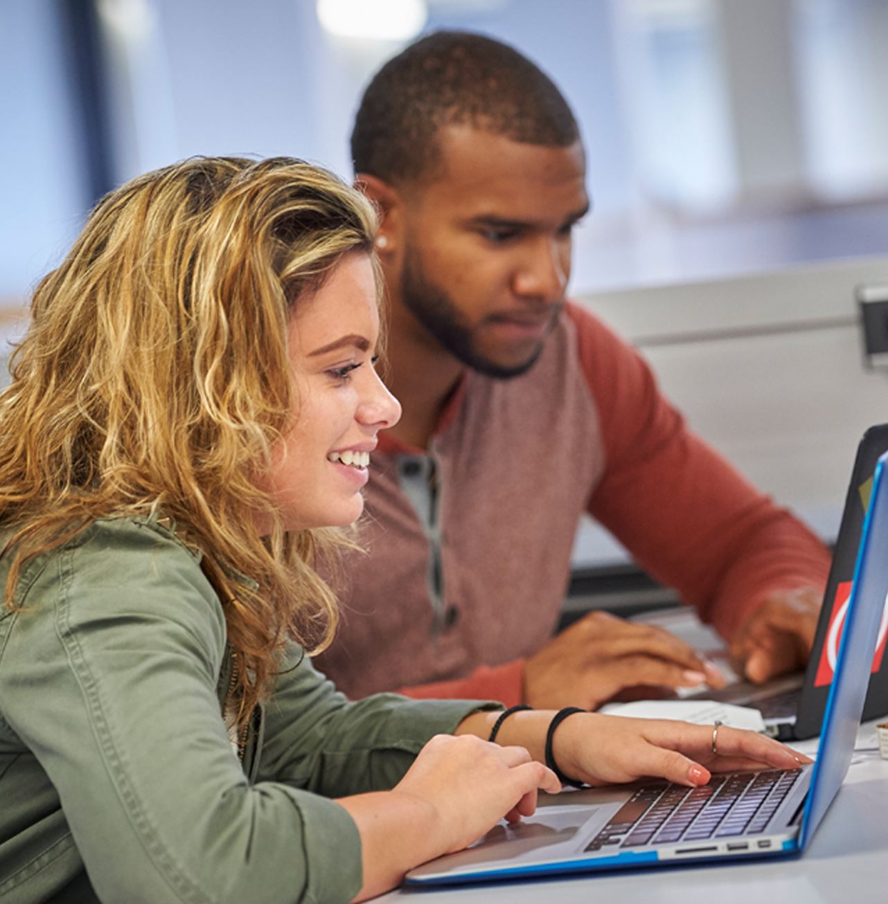 Students discussing with laptop