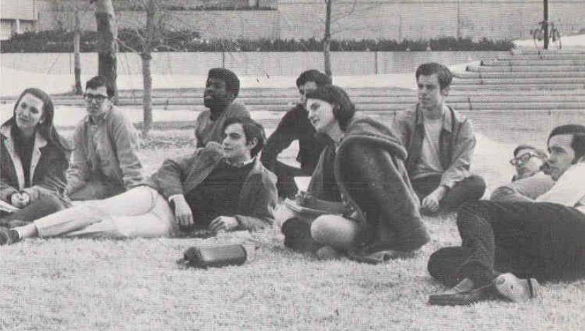 Alumni laying on campus lawn