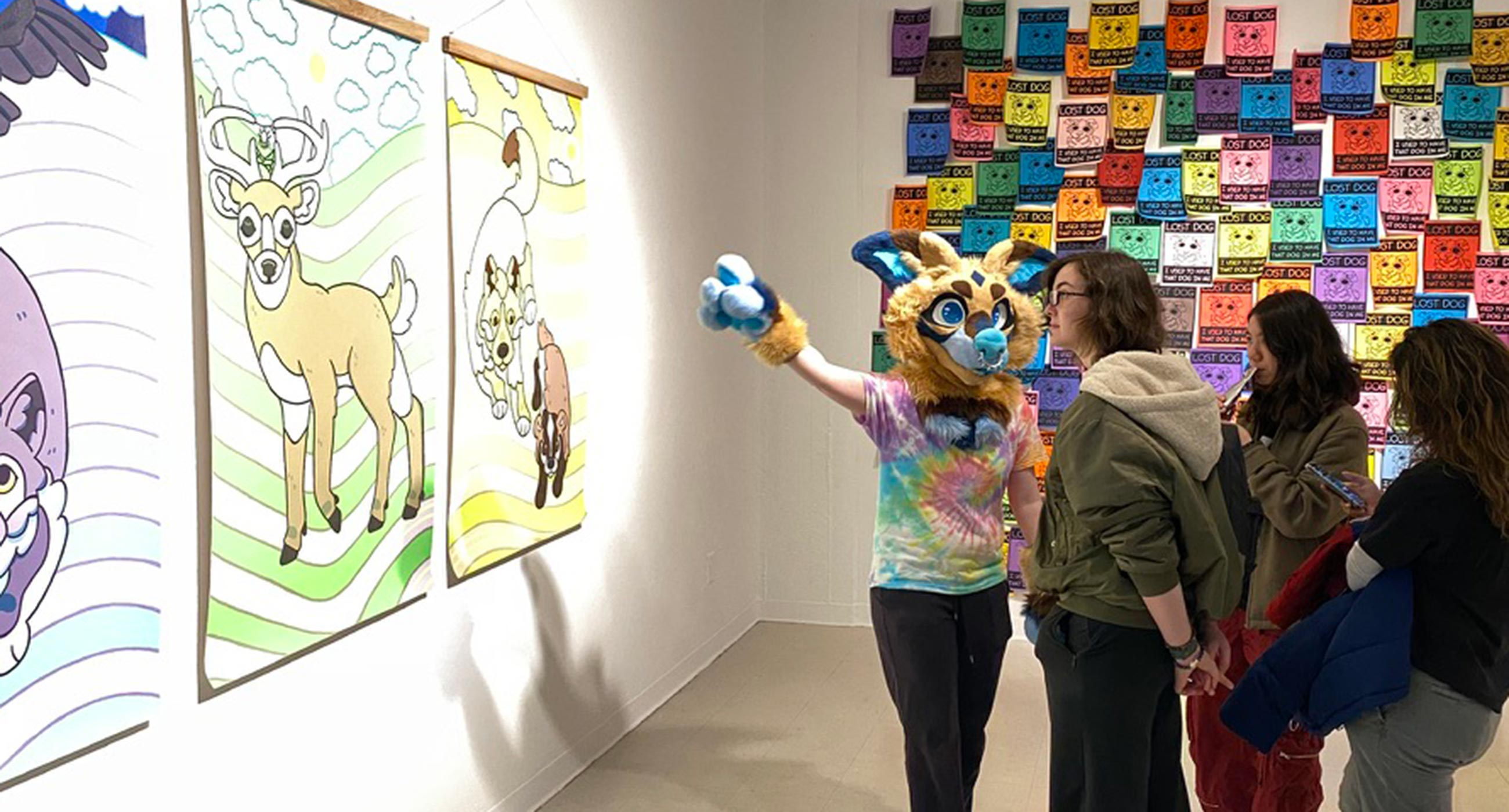 Danielle Henneborn explains her artwork while wearing an animal costume.