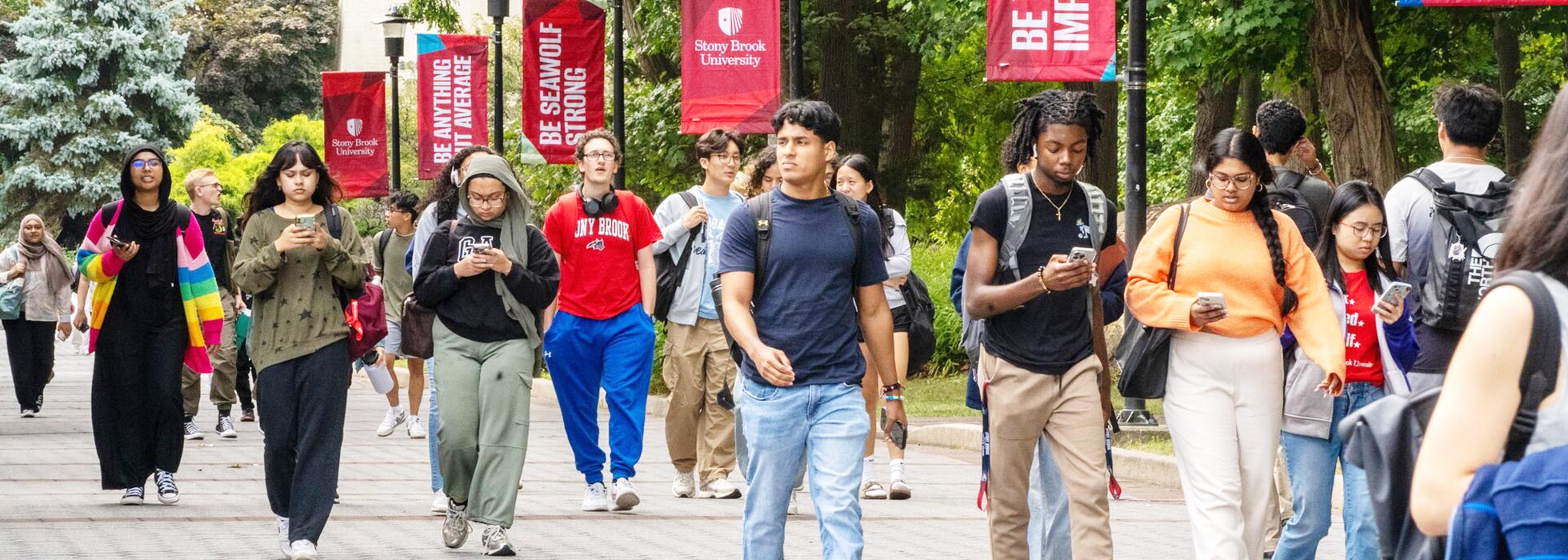 Students walking through the lush, greenery-filled Academic Mall.