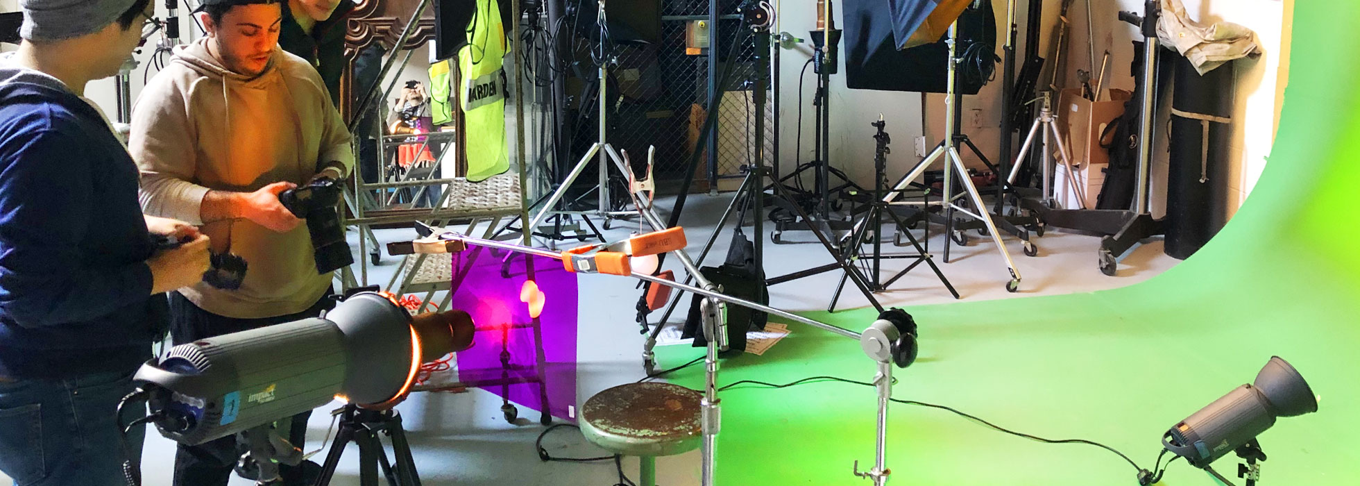 Students creating superimposed footage in front of a green screen.