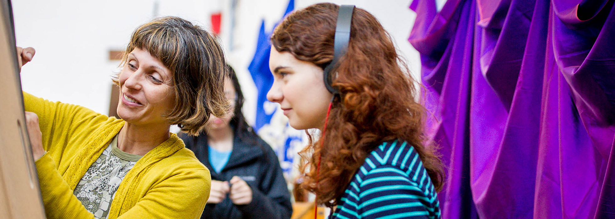 A picture depicting an MFA instructor supervising an undergraduate student.