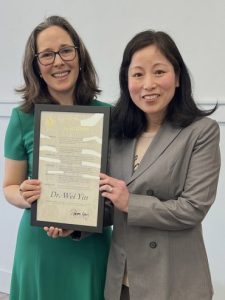 Dr. Yin award Dr. Yin with representative Kassay