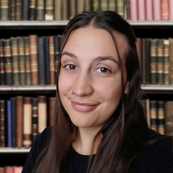 Jessica Infanzon Jessica Infanzon poses in front of a bookshelf