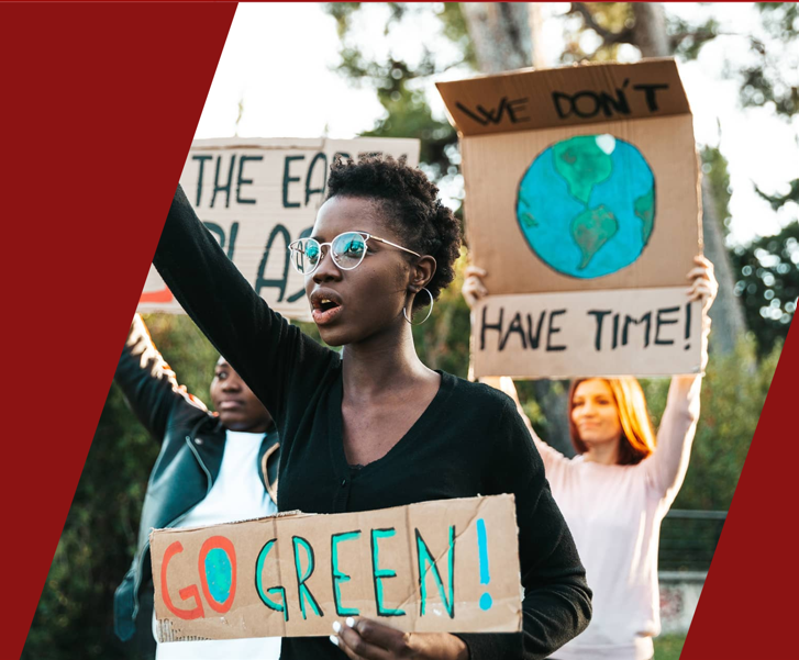 woman in a protest holding a sign "go green"