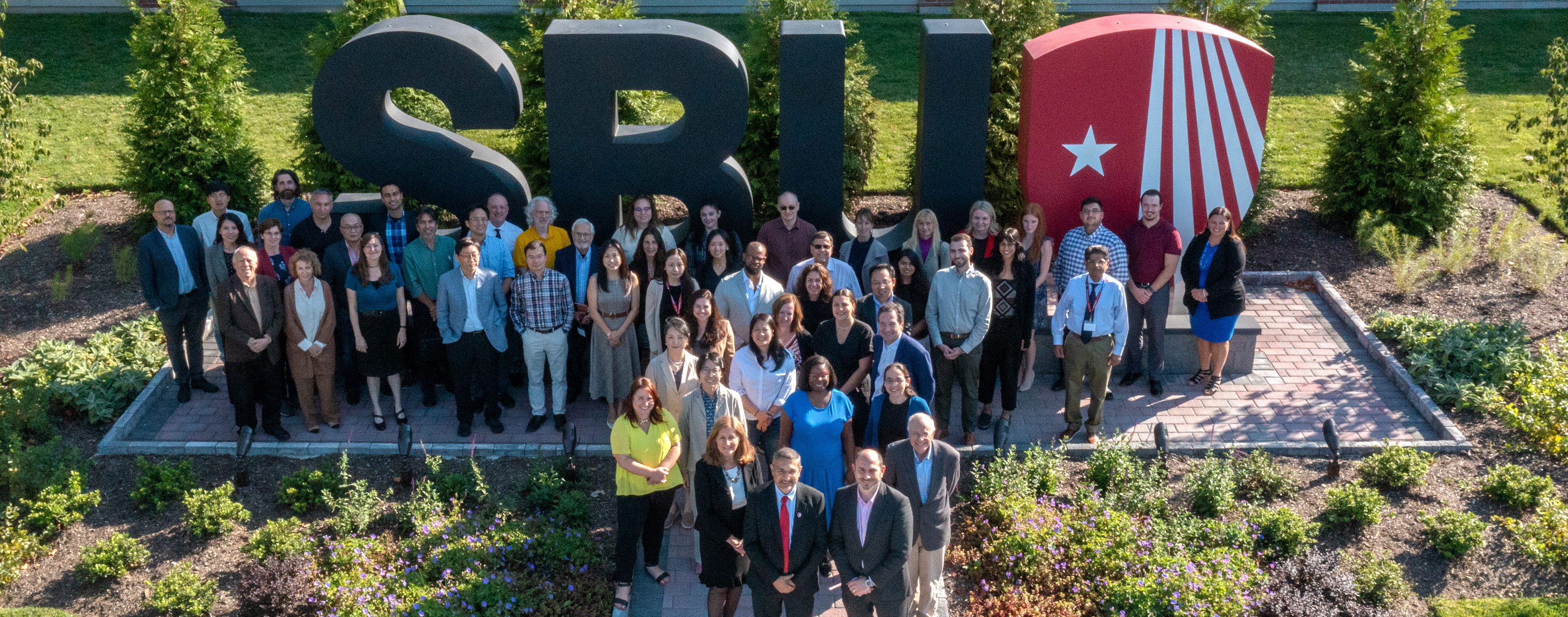 SUNY Stony Brook University College of Business Faculty and Staff Group Photo in front of the SBU Landmark Letters