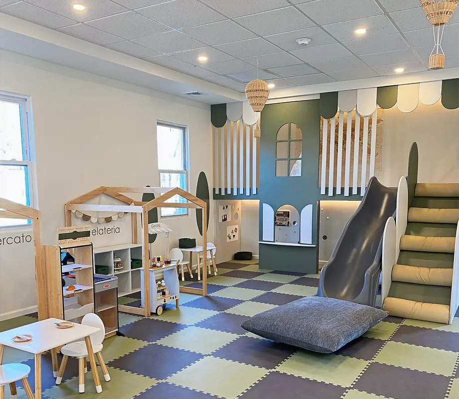 photo of interior of Per Tutti. Shows a play area with toys and stations