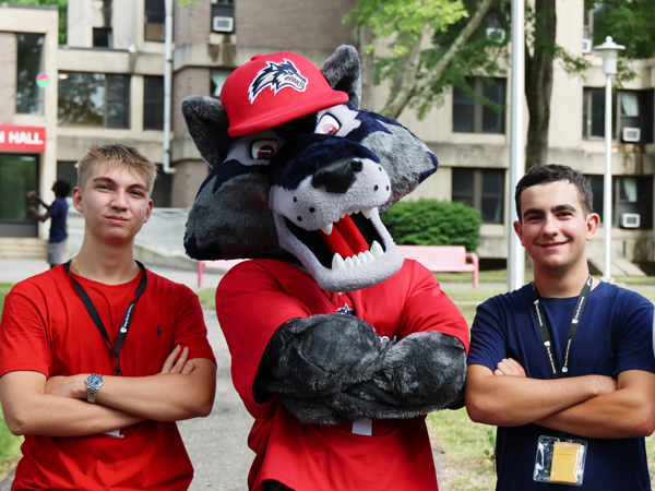 Students and wolfie outside of the residence hall