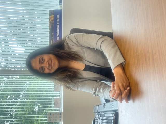 Photo of Vasihali sitting at a desk.
