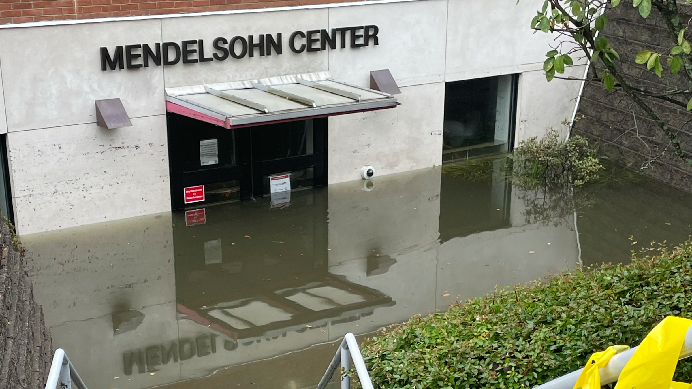 Flood waters at door handle height in front of Mendelsohn Center