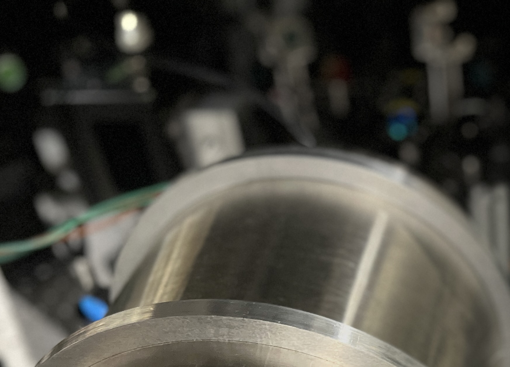Close-up view of the cylindrical metallic laboratory component with a blurred background.