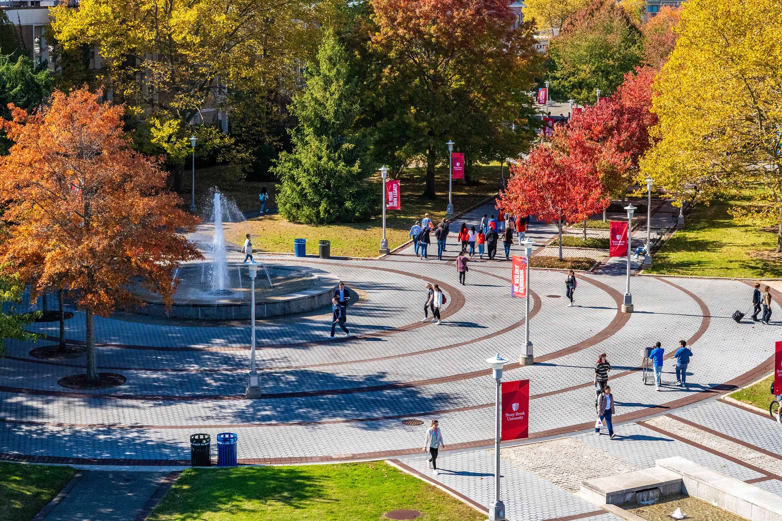 Aerial view of Stony Brook campus in fall with students walking