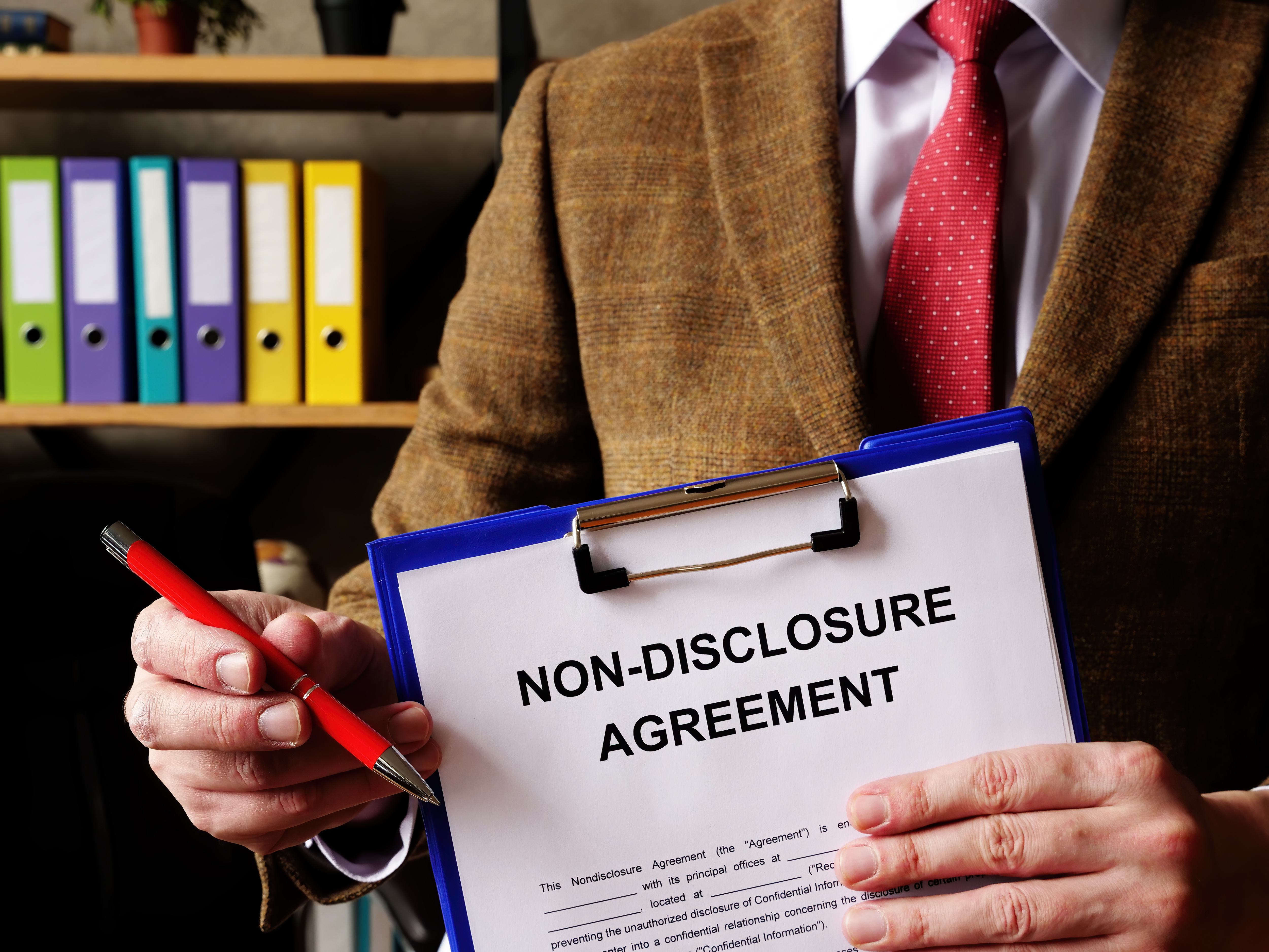 Person holding non-disclosure agreement document