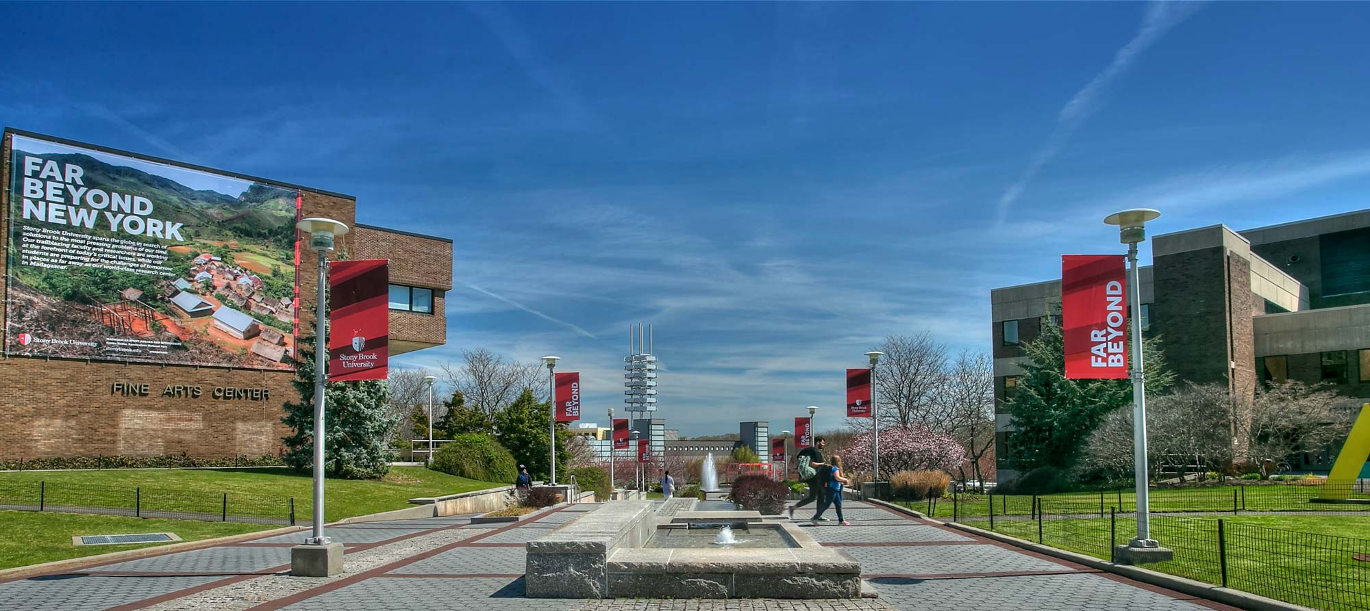 Stony brook campus walkway with university flags
