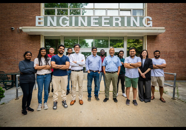 MSCE faculty, researchers, and students posing together in front of the Engineering building entrance