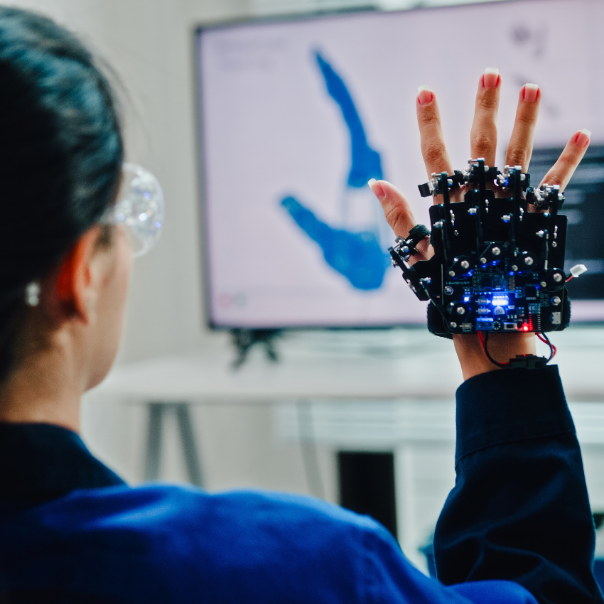 A researcher wears a robotic hand prosthesis