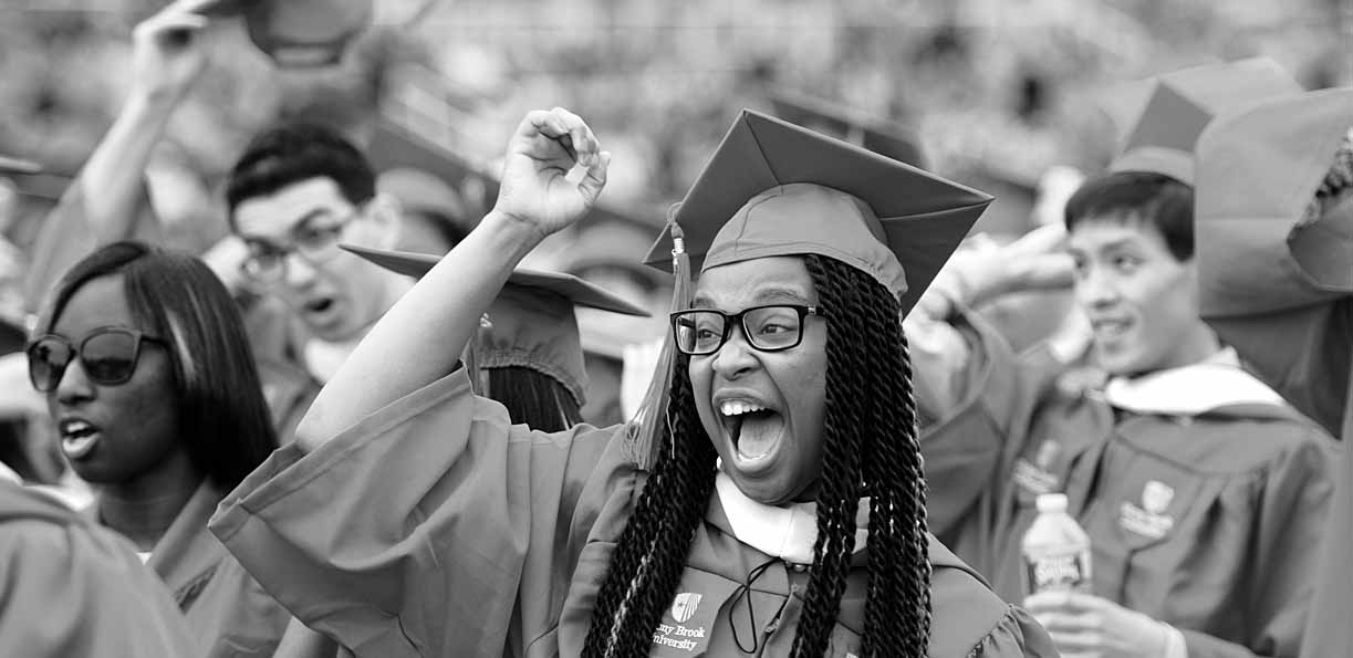 A black and white photo of students celebrating at the  graduation ceremony