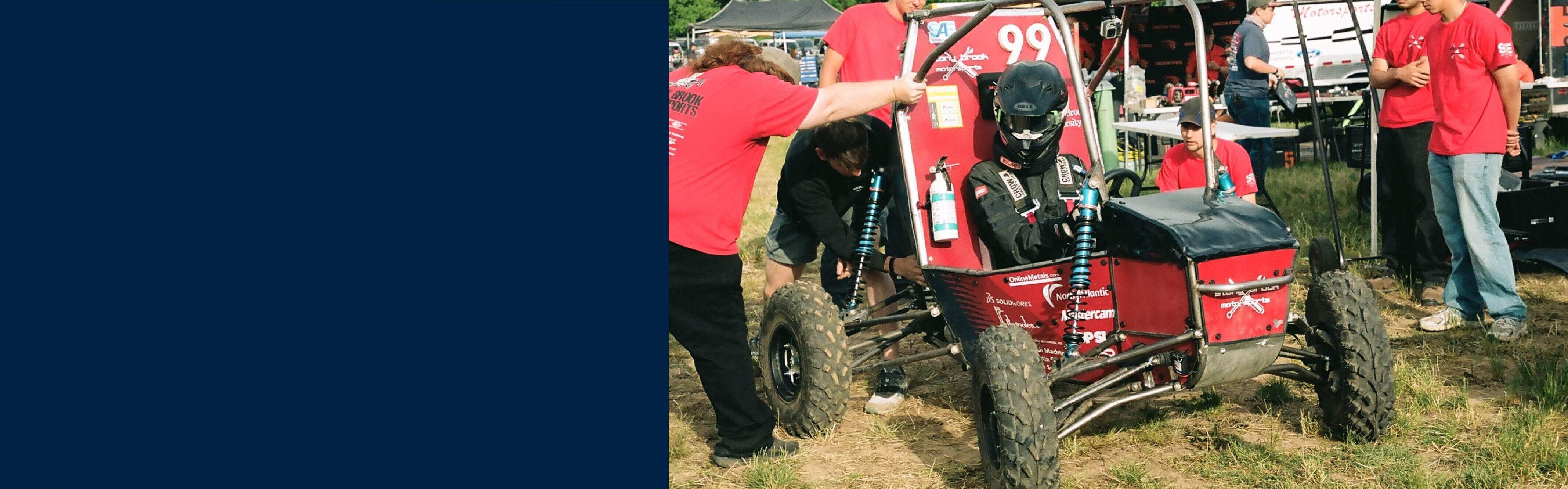 Motorsports team members inspecting the SBU car