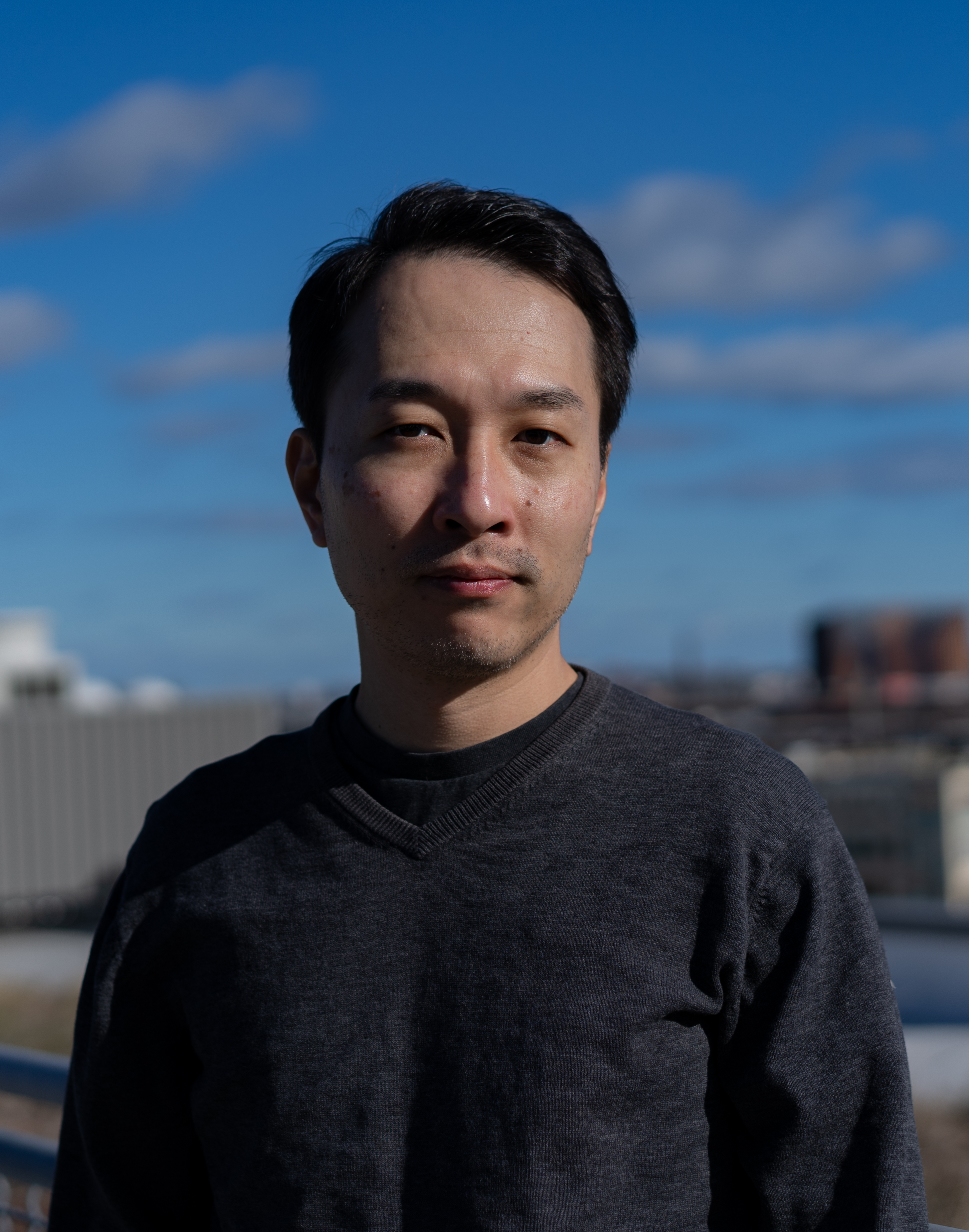 Headshot of Jun Takatoh against a skyline