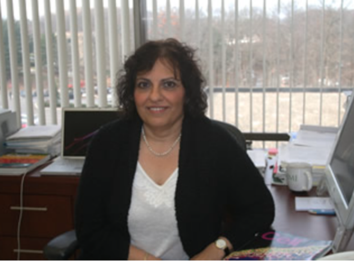 Nurit Ballas sitting at office desk