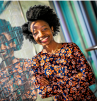 Marcia-Ruth Ndege standing at a window