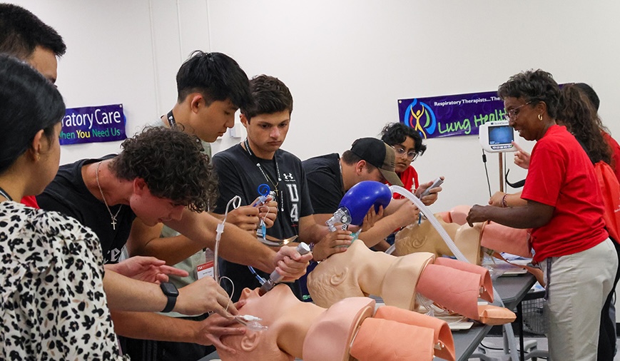 Students practicing intubations on "patient" dummies