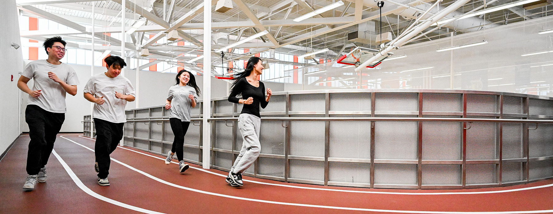 Student running on an indoor track.