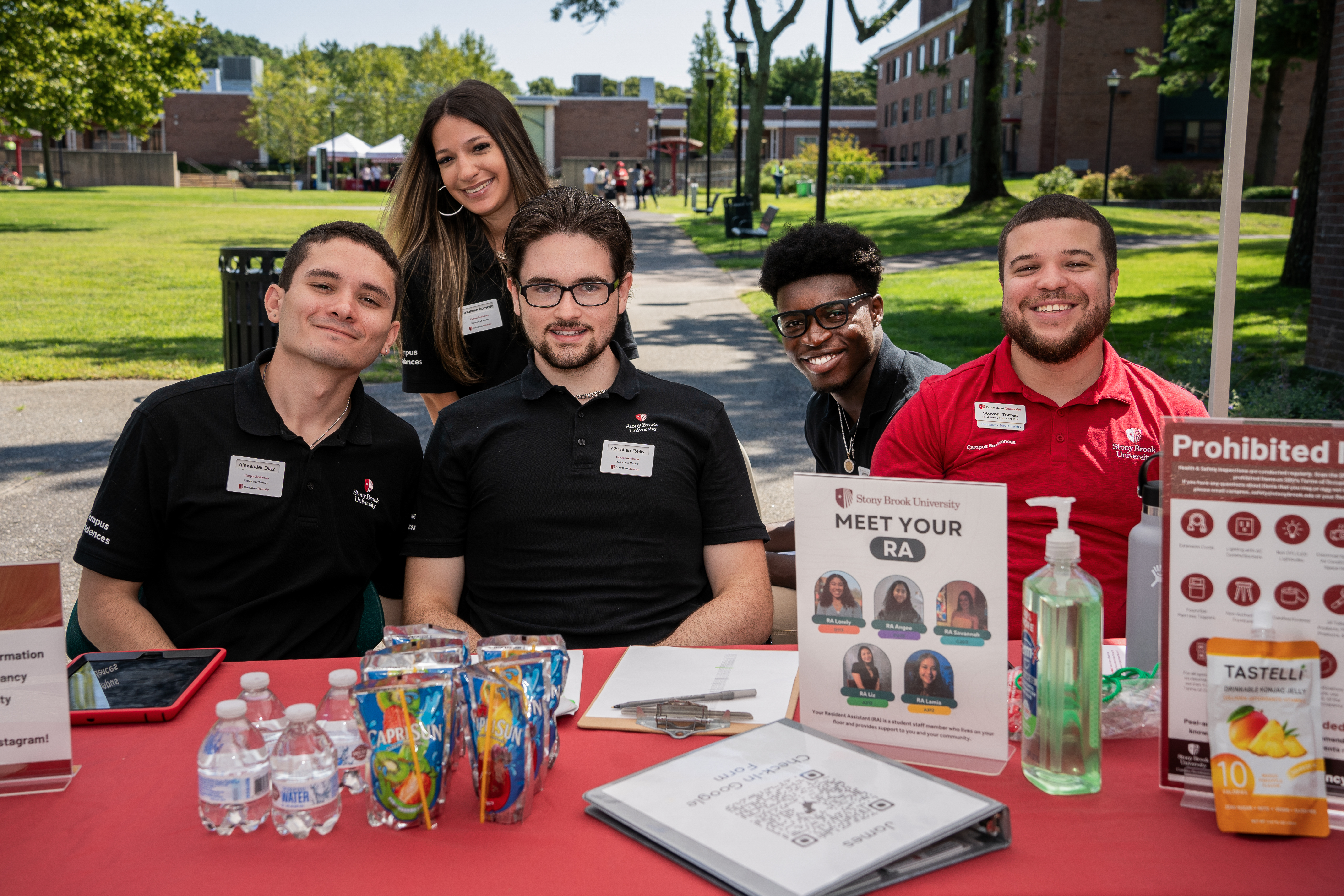 Resident Assistants work at a check-in table during move-in