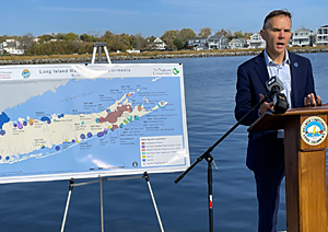 man in front of map of long island