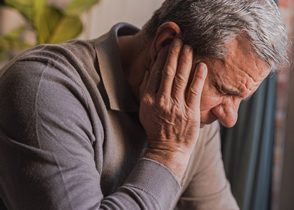 Man holding head up with hand