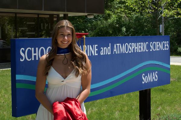 Anna Meichenbaum stands in front of the SoMAS sign at graduation Anna Meichenbaum stands in front of the SoMAS sign at graduation