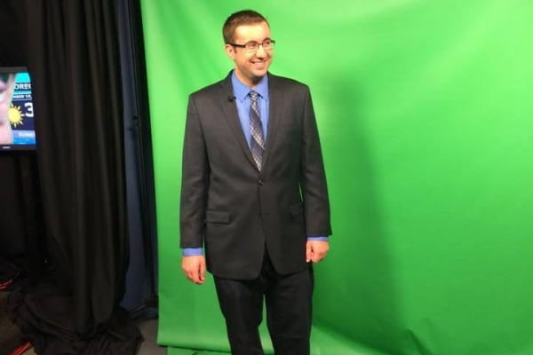 Michael Colbert stands in front of a green screen Michael Colbert stands in front of a green screen