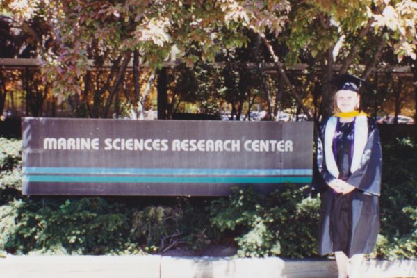 Michele Fischer stands next to the sign for the Marine Sciences Research Center Michele Fischer stands next to the sign for the Marine Sciences Research Center