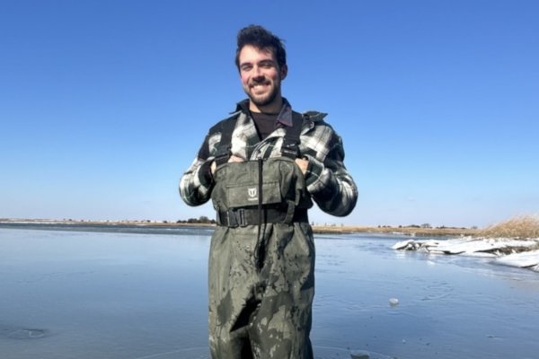 Peter Martin stands in waders in the water