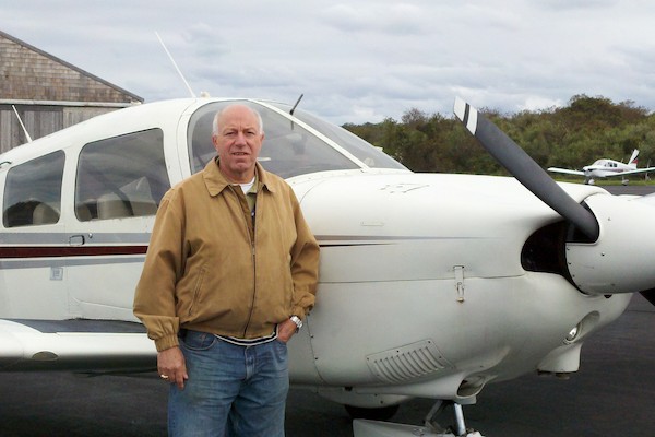 Ron Saporita stands in front of his airplane