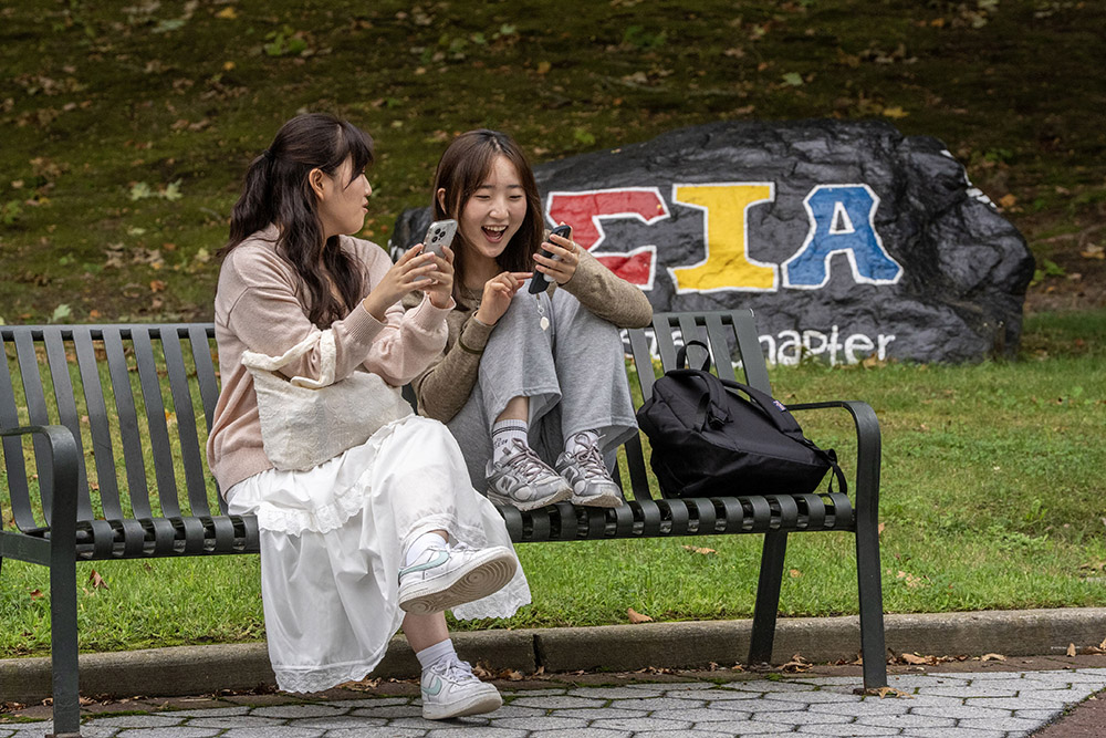 students on campus bench